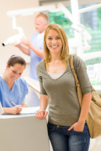 Woman standing by reception desk